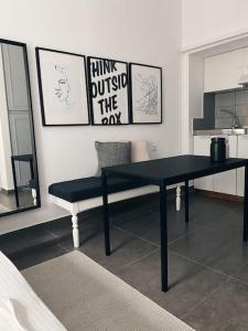 a black table and a bench in a room at City Center Studio Apartment in Heraklio