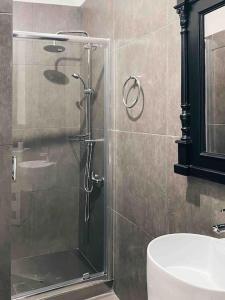 a shower with a glass door in a bathroom at City Center Studio Apartment in Heraklio