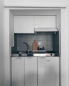 a kitchen with a sink and a stove at City Center Studio Apartment in Heraklio