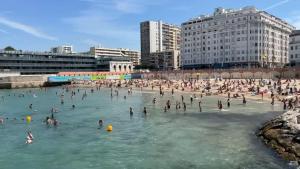 a group of people in the water at a beach at Plage des catalans appart 4 personnes in Marseille