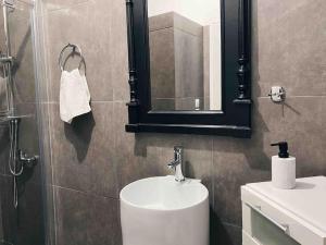 a bathroom with a sink and a mirror at City Center Studio Apartment in Heraklio