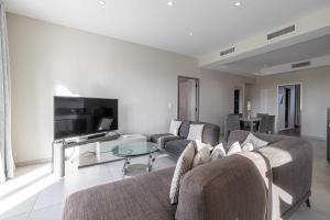 uma sala de estar com dois sofás e uma televisão em Splendid apartment Sea view Parking - Croisette em Cannes