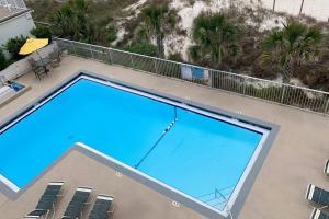 an overhead view of a swimming pool on a balcony at Ambassador 311 in Panama City Beach