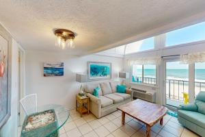 a living room with a couch and a table at Ambassador 311 in Panama City Beach