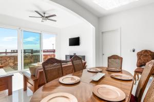a dining room with a wooden table and chairs at Casa Roble 24 - Playa Arcangel in Rosarito