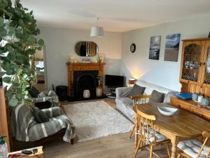 a living room with a couch and a table at Glenbeigh Holiday Cottage - Tigin Mamo in Glenbeigh