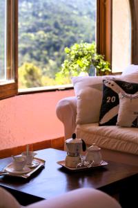 a coffee table with a tea set on it next to a couch at NSM Villa Carlotta E Villa Guarda che Mare in Vieste - Gargano- Puglia in Pugnochiuso +73 photos