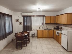 a kitchen with a table and a white refrigerator at Saint Thomas sea view in Preveza