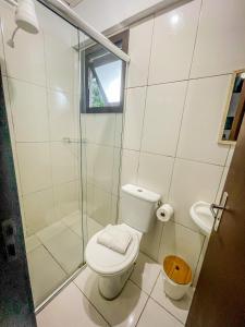 a white bathroom with a toilet and a shower at Hospedagem Vida e Natureza in Gramado +64 photos