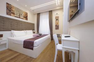 a hotel room with a bed and a desk at Alla Locanda Malandra in Rome