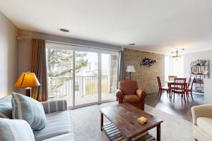 a living room with a couch and a table at Rehoboth Beach -- The Crest #303 in Rehoboth Beach