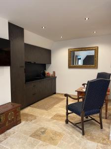 a living room with a table and chairs and a television at Brezno Central Apartments in Brezno