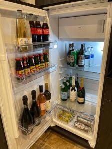 een open koelkast gevuld met veel flessen alcohol bij Brezno Central Apartments in Brezno