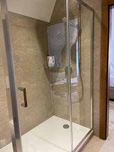 a shower with a glass door in a bathroom at Brezno Central Apartments in Brezno
