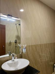 a bathroom with a sink and a mirror at Pine Tree Resort in Nagarkot