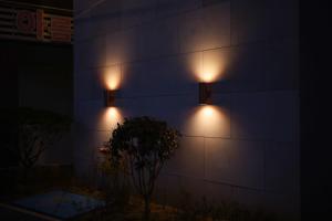 duas luzes ao lado de um edifício à noite em From H Heritage Hotel em Mokpo