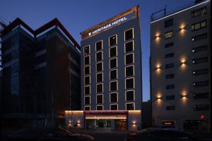 a tall building with a sign on the side of it at From H Heritage Hotel in Mokpo