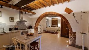 a kitchen with an archway and a room with a bed at La Murata in Rapolano Terme