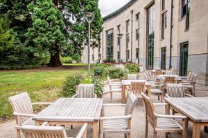 a row of tables and chairs in front of a building at Stephen Hawking Building Gonville and Caius College in Cambridge +7 photos