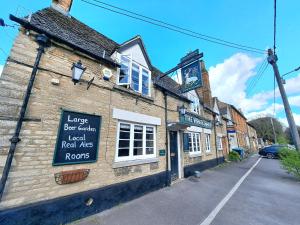 an old brick building with a sign on it at The White Hart in Oxford