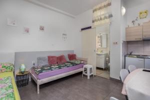 a small room with a bed and a kitchen at Villa Dora ##3 in Crikvenica