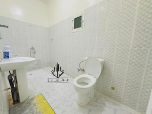 a bathroom with a toilet and a sink at Kane house in Nouakchott