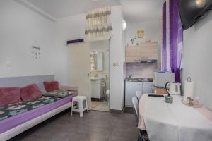 a small room with a bed and a kitchen at Villa Dora ##3 in Crikvenica