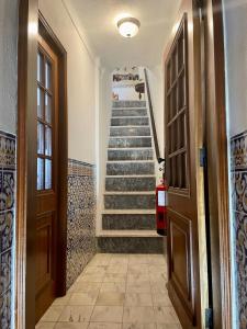 a hallway with a staircase in a house at Casa David in Castelo de Vide