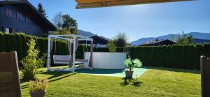 a garden with a swing in the grass at Villa Juwel in Altenmarkt im Pongau