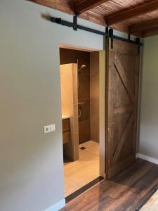 a bathroom with a shower and a sliding barn door at B&B Hoeve Fraai Achterhoek in Aalten
