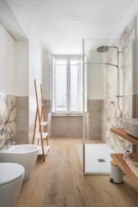 a bathroom with a shower and a toilet and a sink at B&B Affittacamere Via del Centro in La Maddalena +25 photos