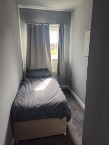 a small bed in a room with a window at 3 Bedroom house, close to woodland, chesterfield and peak District in Brimington
