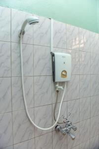 a hose hooked up to a shower in a bathroom at COZY COOL ,WIFI 6 MINS WALK TO ACACIA MALL in Kampala