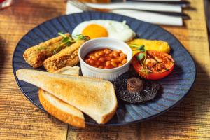 a blue plate of breakfast food with toast and beans at Saint Pauls House in Birmingham