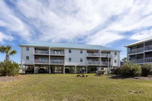 an apartment building with a park in front of it at Palmetto 306 in Orange Beach