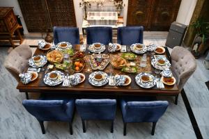 a table with plates of food on it at Dar Al Makam - Luxury Experience in Soliman