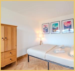 a bedroom with a bed and a dresser at Chez Fan & Alex St Julien in Saint-Julien-en-Genevois