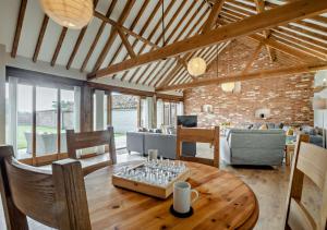 a living room with a wooden table and a couch at Barley Barn in Kimberley