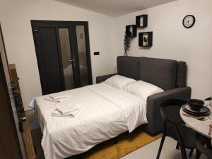 a bedroom with a bed and a clock on the wall at Apartment Boras in Vir