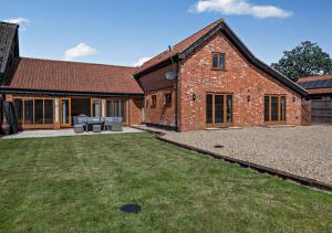 an external view of a brick house with a yard at Barley Barn in Kimberley