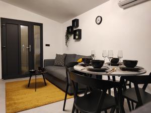 a living room with a table and a couch at Apartment Boras in Vir +22 photos