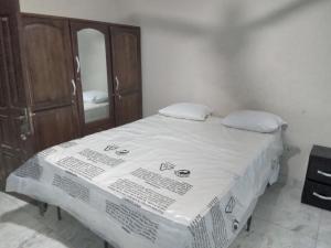 a bedroom with a bed with a dresser and a mirror at Captivating 1-Bed Lodge in Accra in Accra