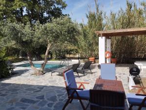 eine Terrasse mit Stühlen und einem Pool in der Unterkunft Elia suites in Ialysos
