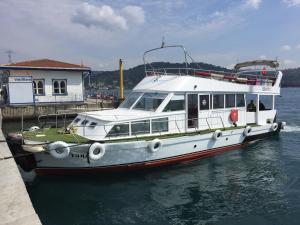 a white boat is docked at a dock at Kmtyachtstanbul in Istanbul