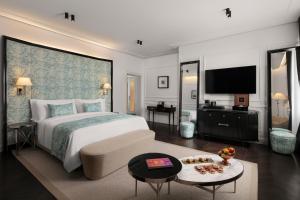 a hotel room with a bed and a television at Sanasaryan Han, a Luxury Collection Hotel, Istanbul in Istanbul