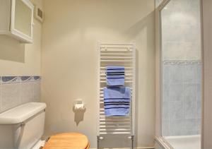 a bathroom with a shower and blue towels at The Stables in Elsing