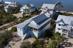 an aerial view of a house with a blue roof at Windmark - Sunset by the Bay in Highland View