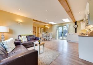 a living room with a couch and a table at Partridge Lodge in Reepham