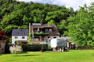 a white house with a yard with a house at Lahn-er-leben in Geilnau