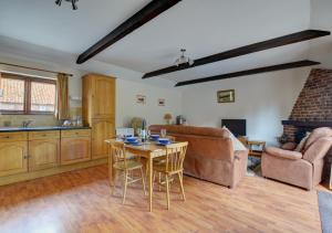 a living room with a table and a couch at The Orchard in Lyng